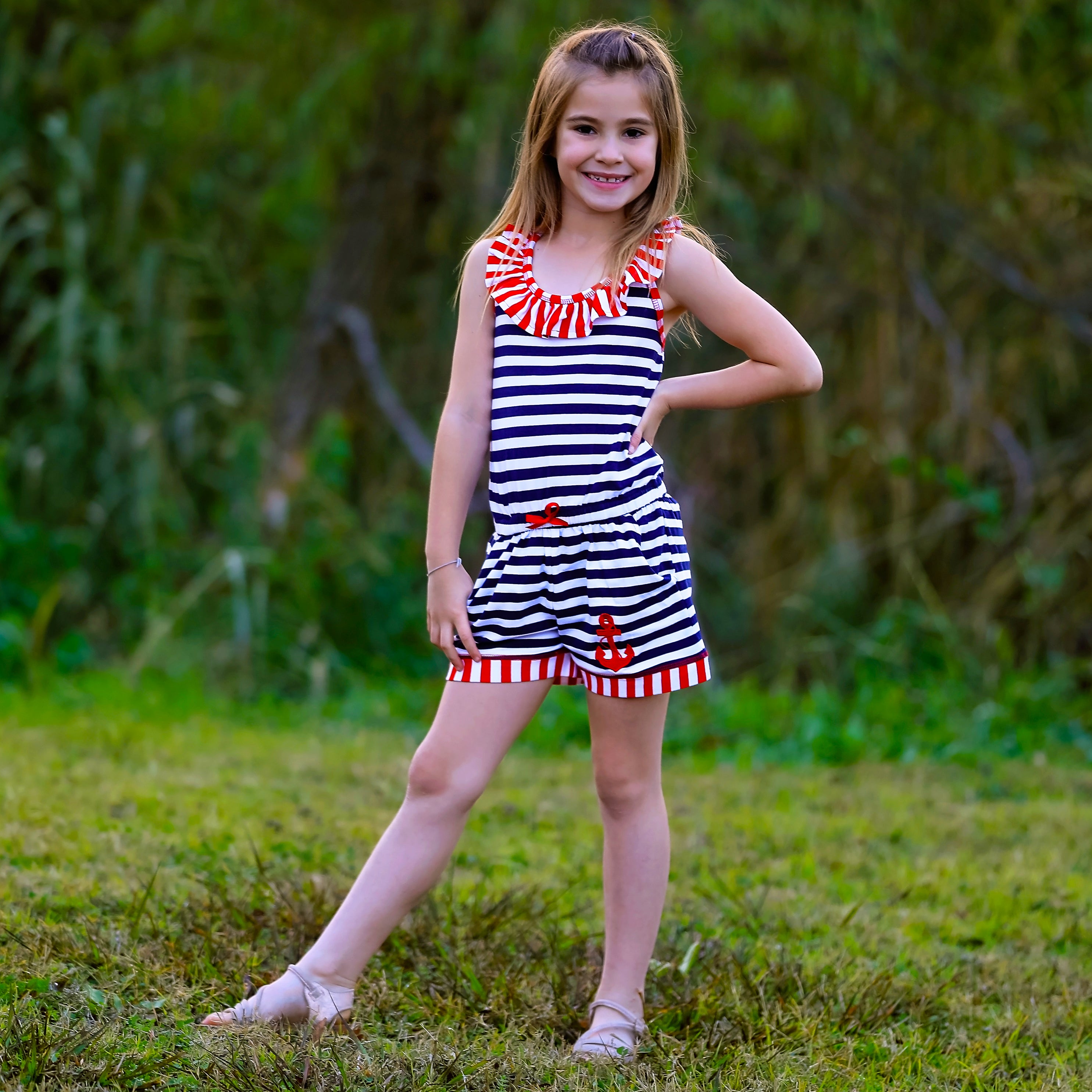 AnnLoren Girls Anchors Away Nautical Jumpsuit featuring criss-cross straps, elastic waist, and pockets, perfect for summer wear.